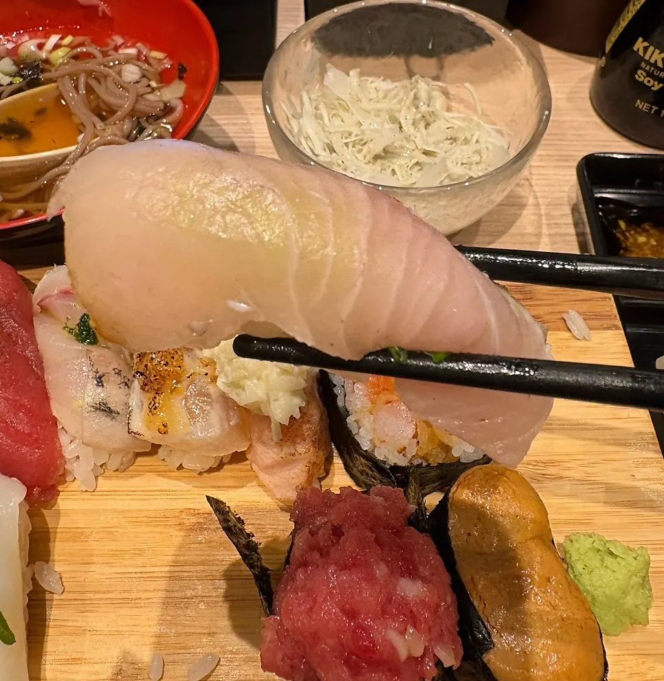A piece of thick white fish sushi