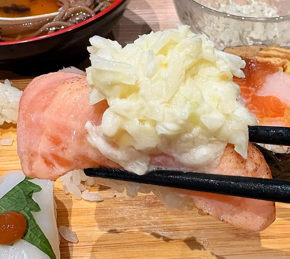 A piece of grilled salmon sushi