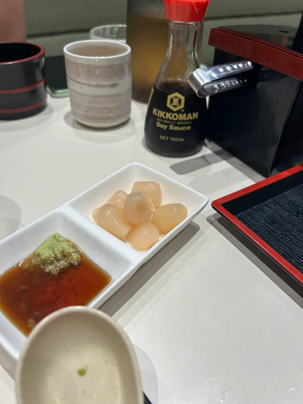 Pickled radish and soy sauce set at each table