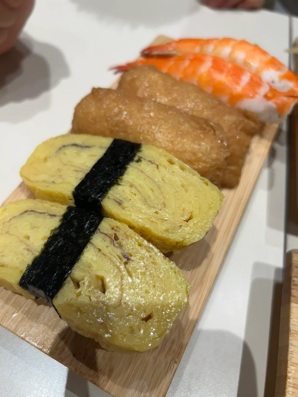 Picking up a piece of sushi to eat