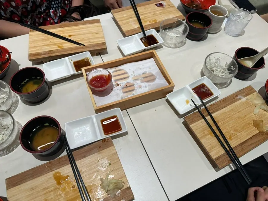 Plate with remaining tuna, shrimp, and egg sushi