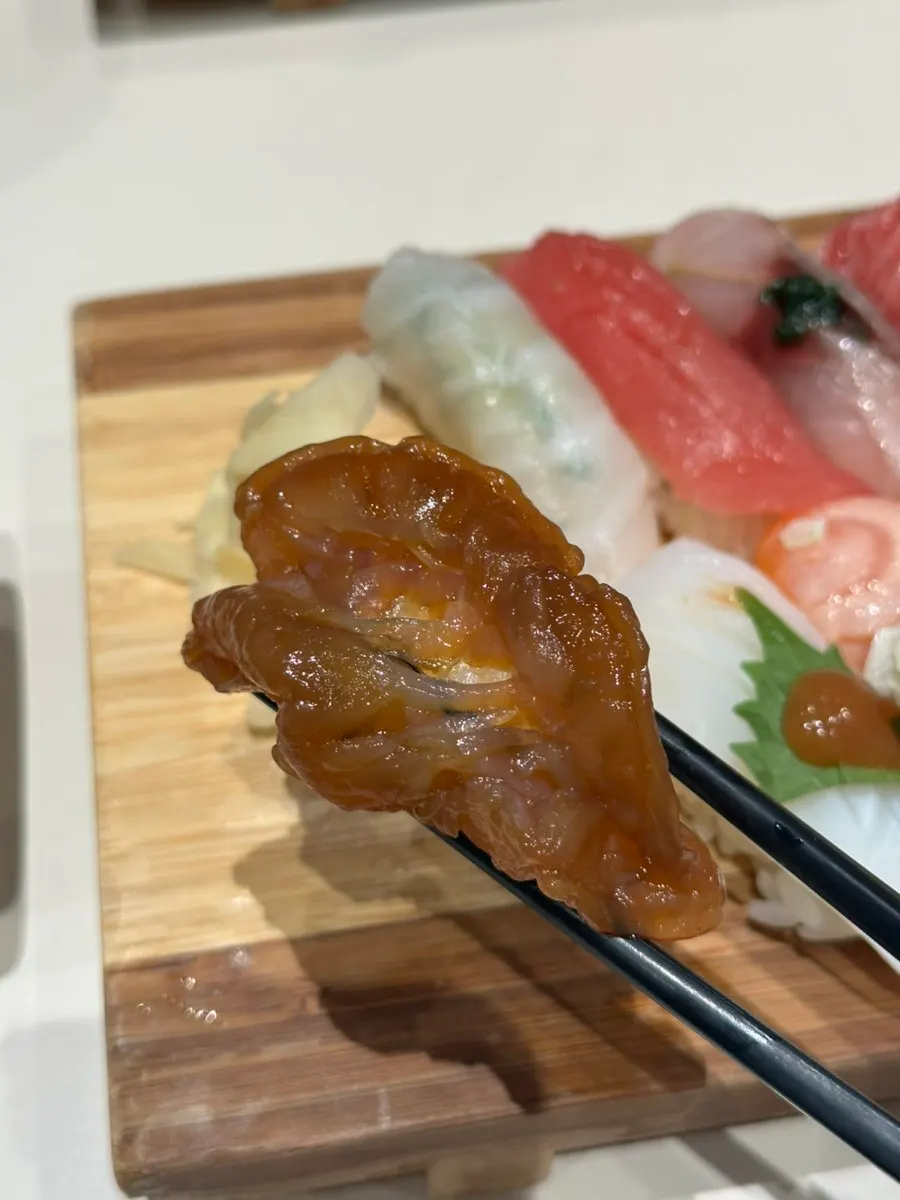 A piece of soy-marinated shrimp sushi