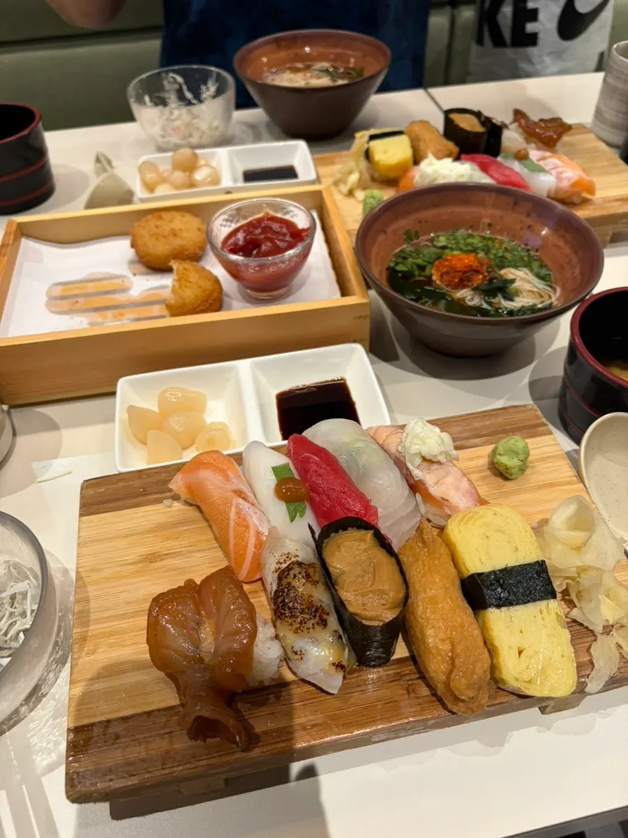 A close-up of a sushi piece topped with aged fish