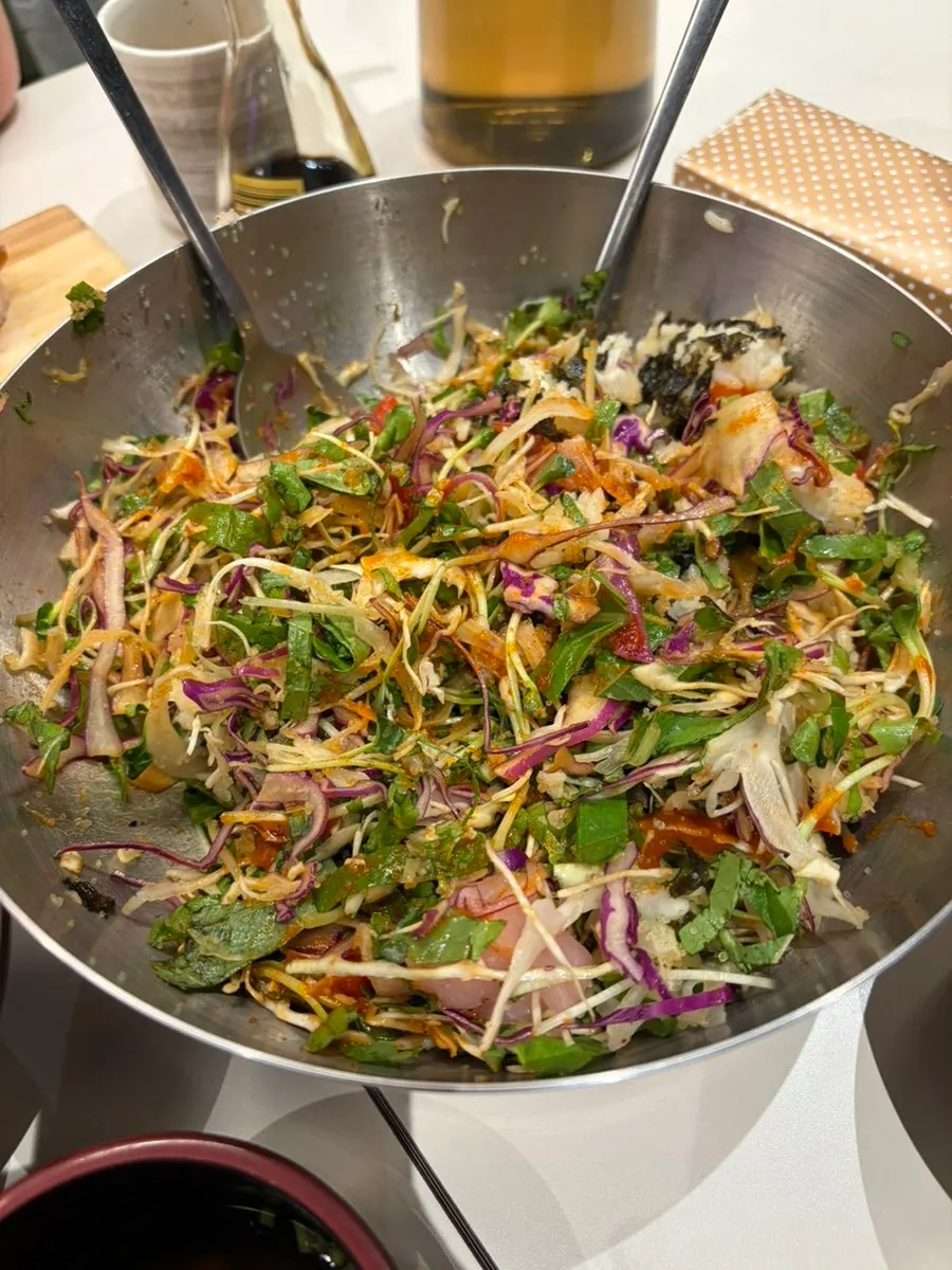 Sashimi rice bowl loaded with vegetables and raw fish