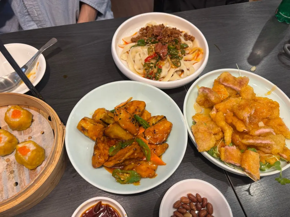 Four dishes set on the table at Cheonghwa Uyuk Dosakmyeon
