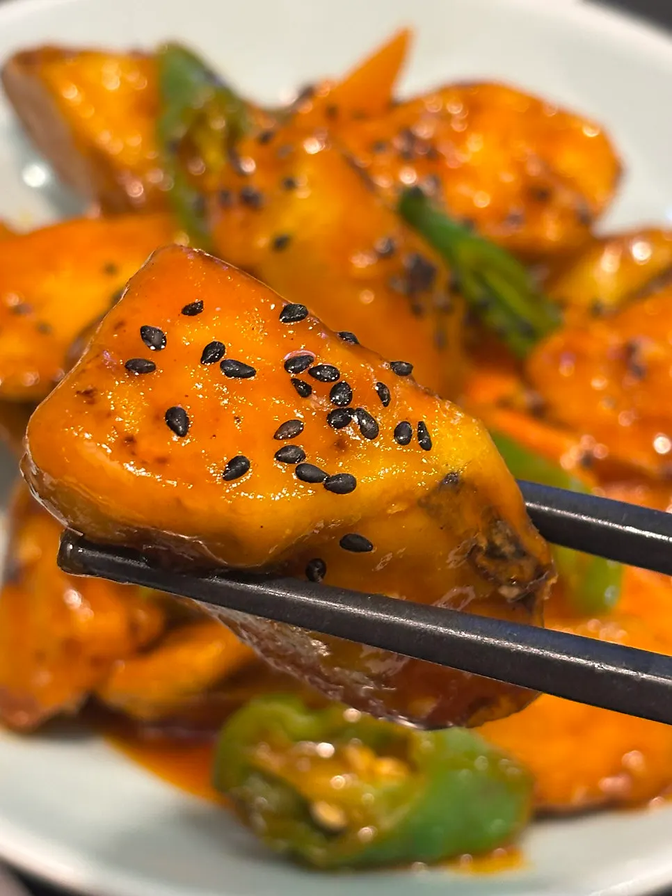 Close-up of crispy sauce-coated eggplant fritters