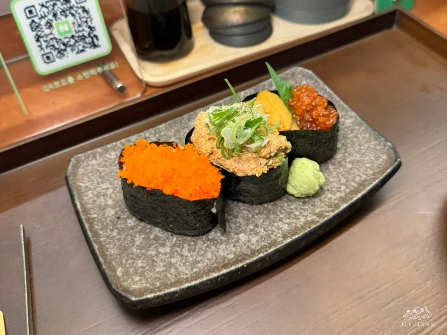 Uni, ikura, ankimo, and flying-fish-roe gunkan sushi