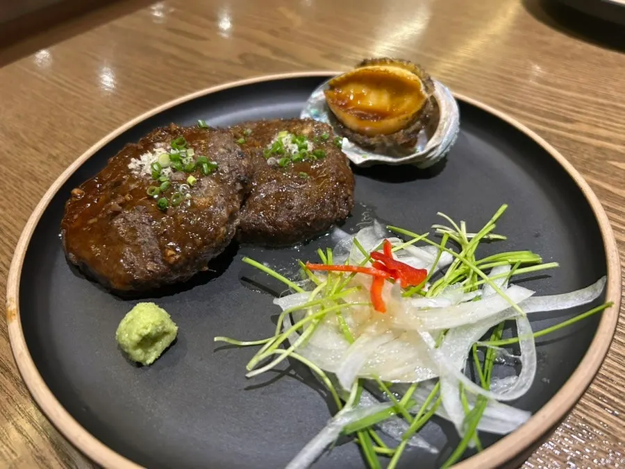 The main abalone tteokgalbi course arrives