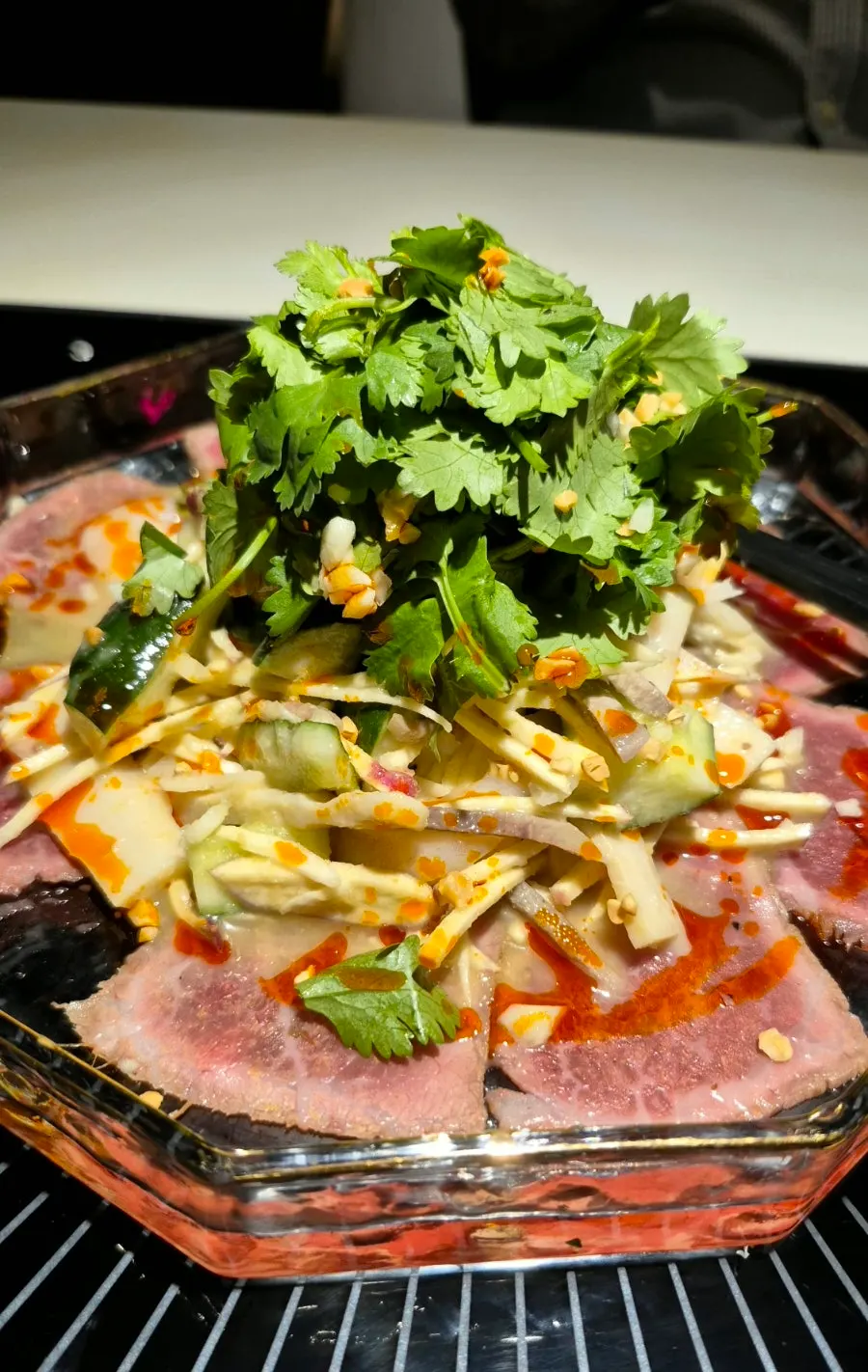 Close-up of beef mustard salad topped with cilantro