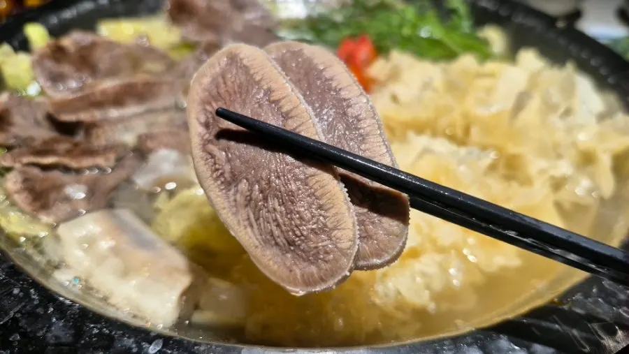Ingredients from the hot pot scooped into a bowl