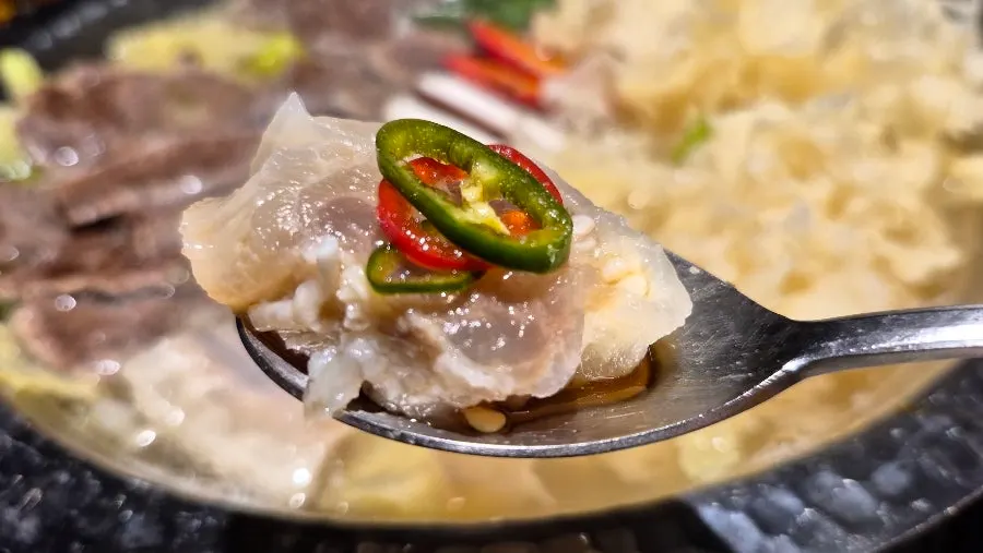 Tripe dipped into the sauce