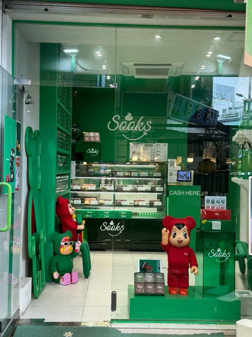 Green storefront of Ssuk's Choco Pie at the market entrance