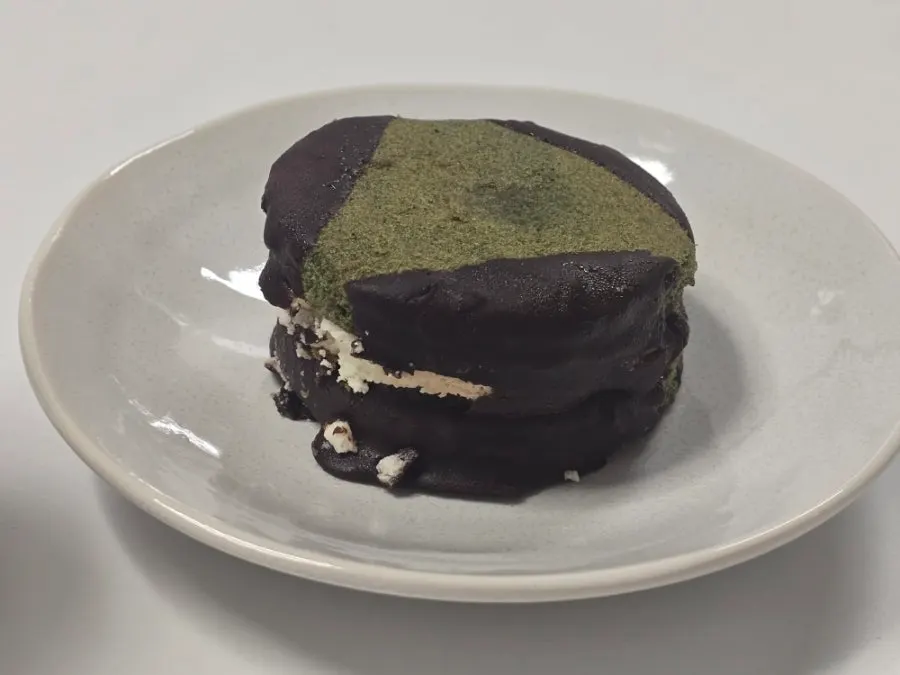 Cross-section of a choco pie with strawberry jam and cream