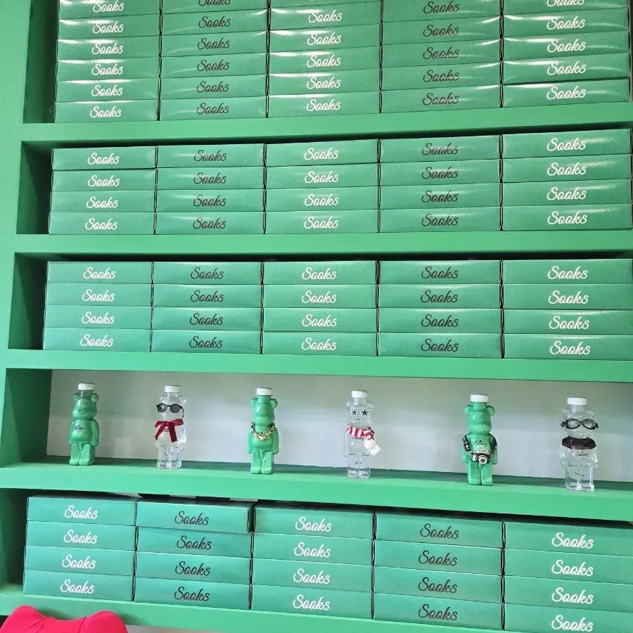 Green gift boxes lined up along the wall