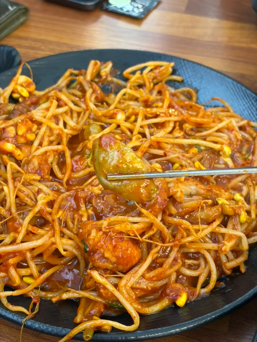 A chopstick bite of boneless monkfish and bean sprouts