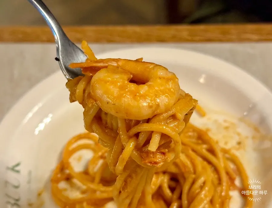 Thick rosé sauce coating the pasta noodles