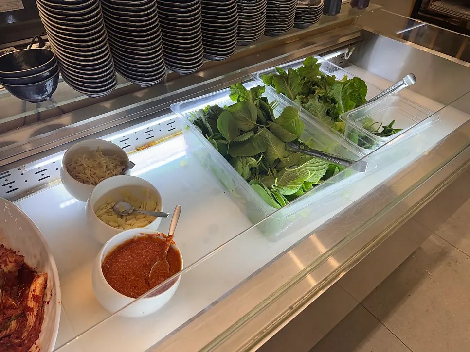 Self-serve bar corner where diners can grab extra side dishes