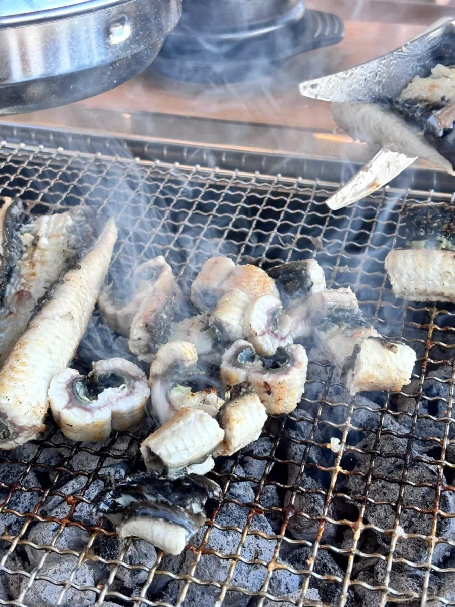 Raw eel placed on the charcoal grate