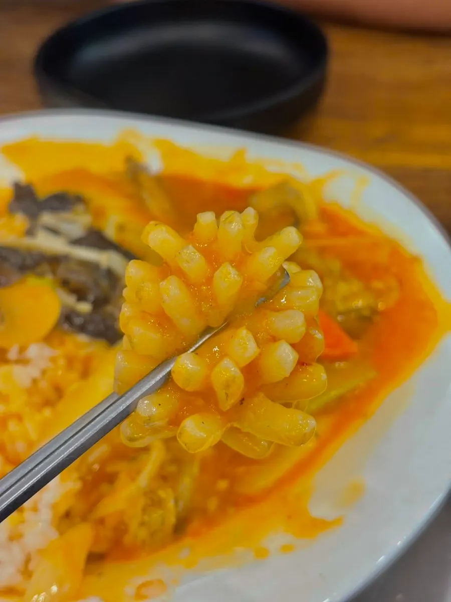 Seafood rice bowl mixed together with its sauce