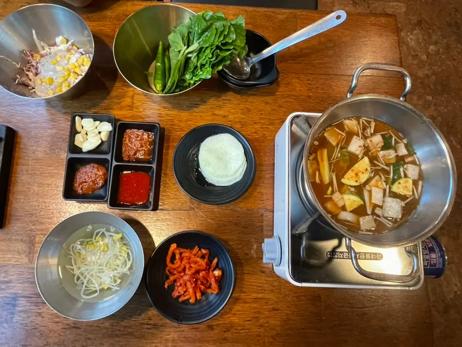 Basic table setting including bean sprout soup and doenjang jjigae
