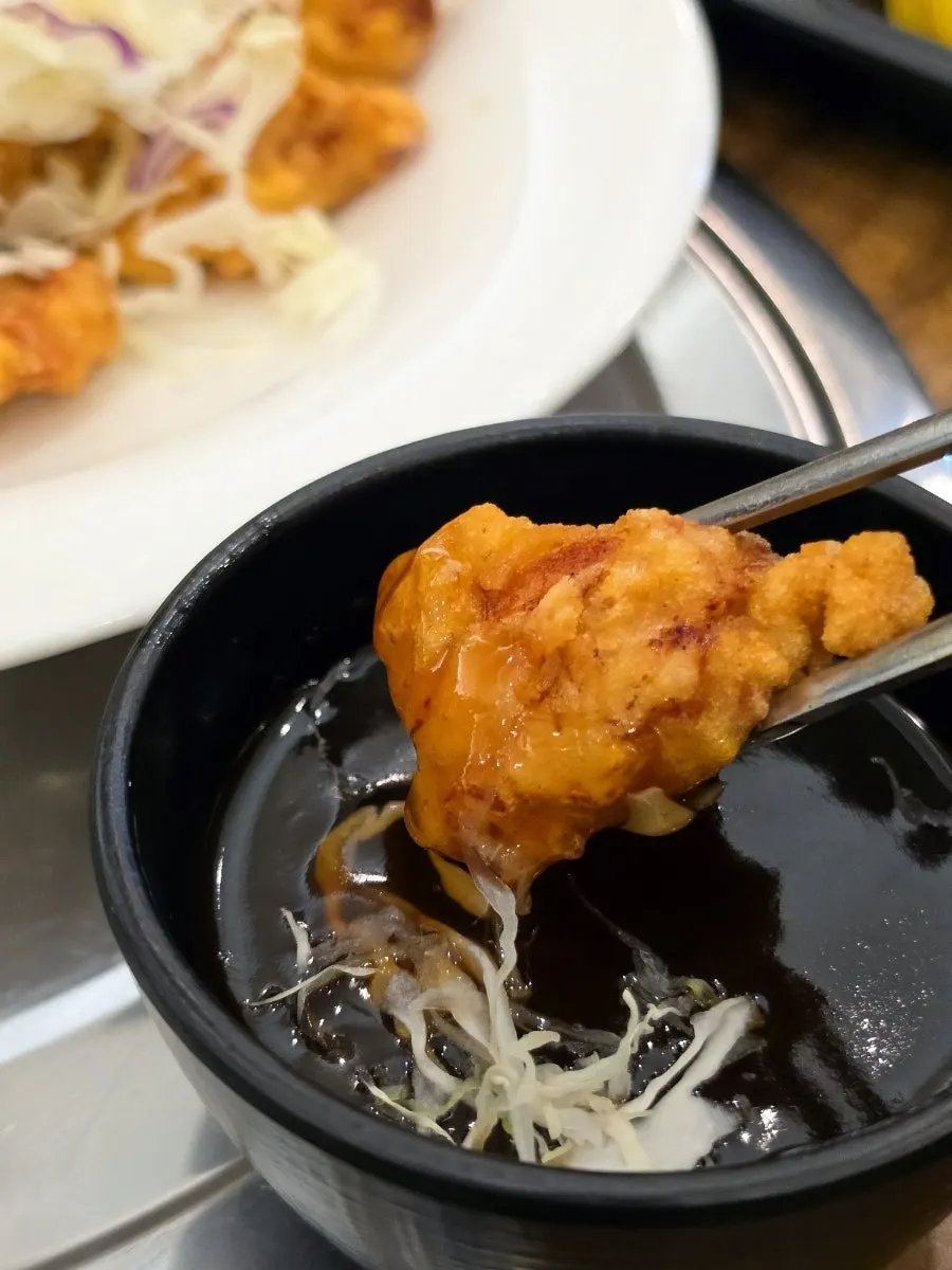 A piece of tangsuyuk dipped in sauce