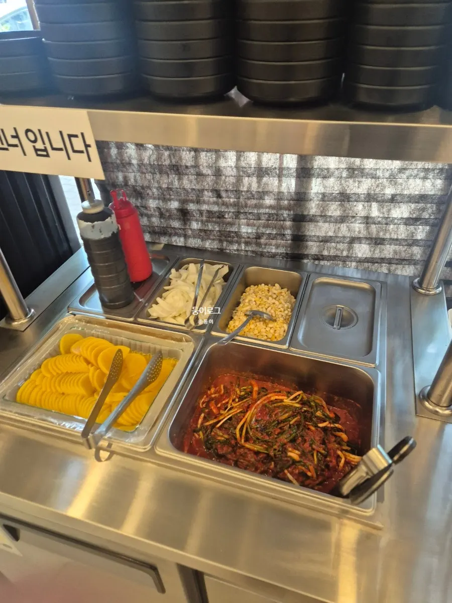 Self-serve side dish corner with green onion kimchi