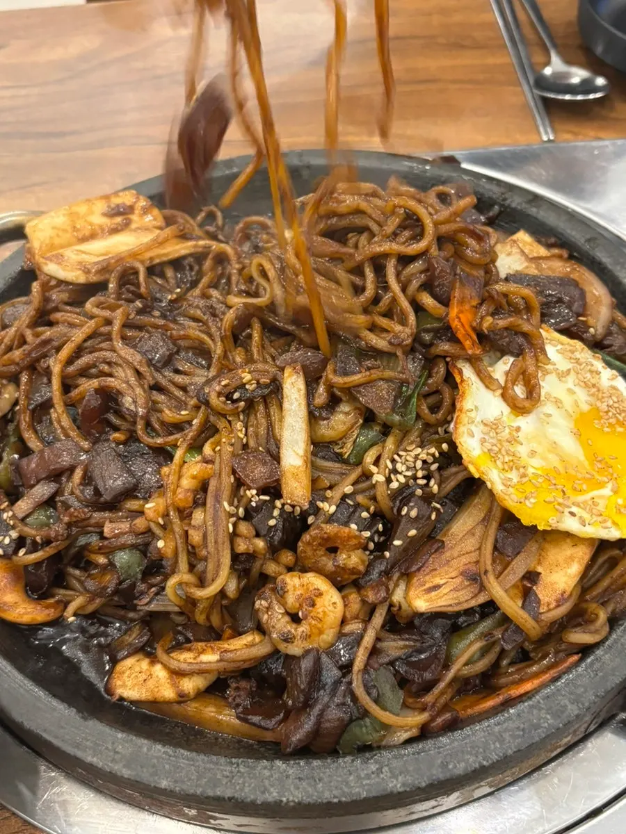 Stone-griddle jjajang served on a hot stone plate