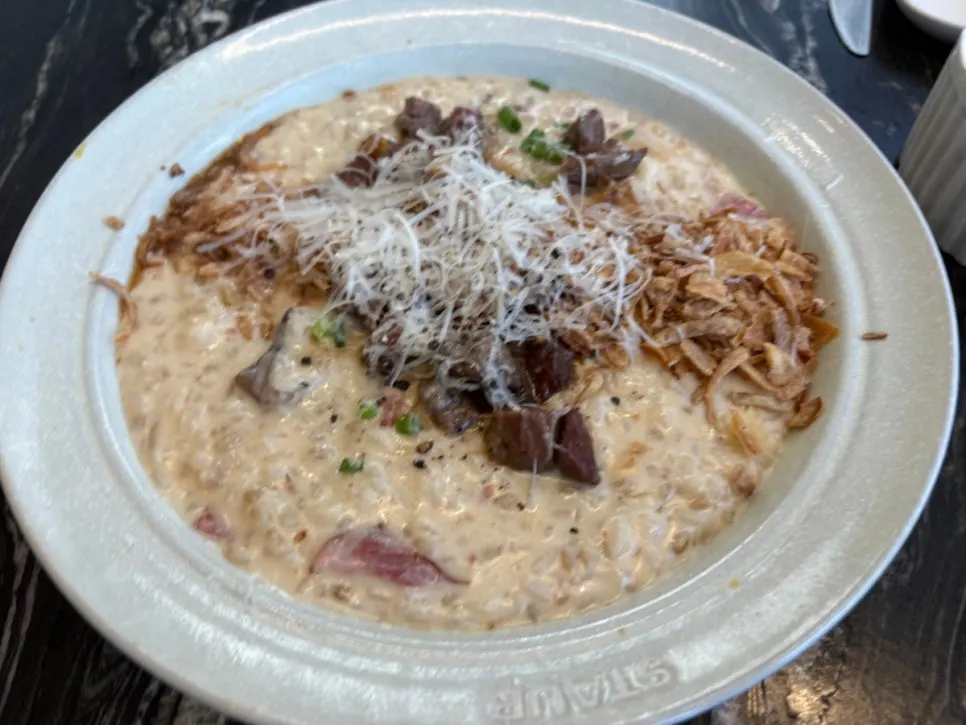 Fork lifting up cream pasta noodles