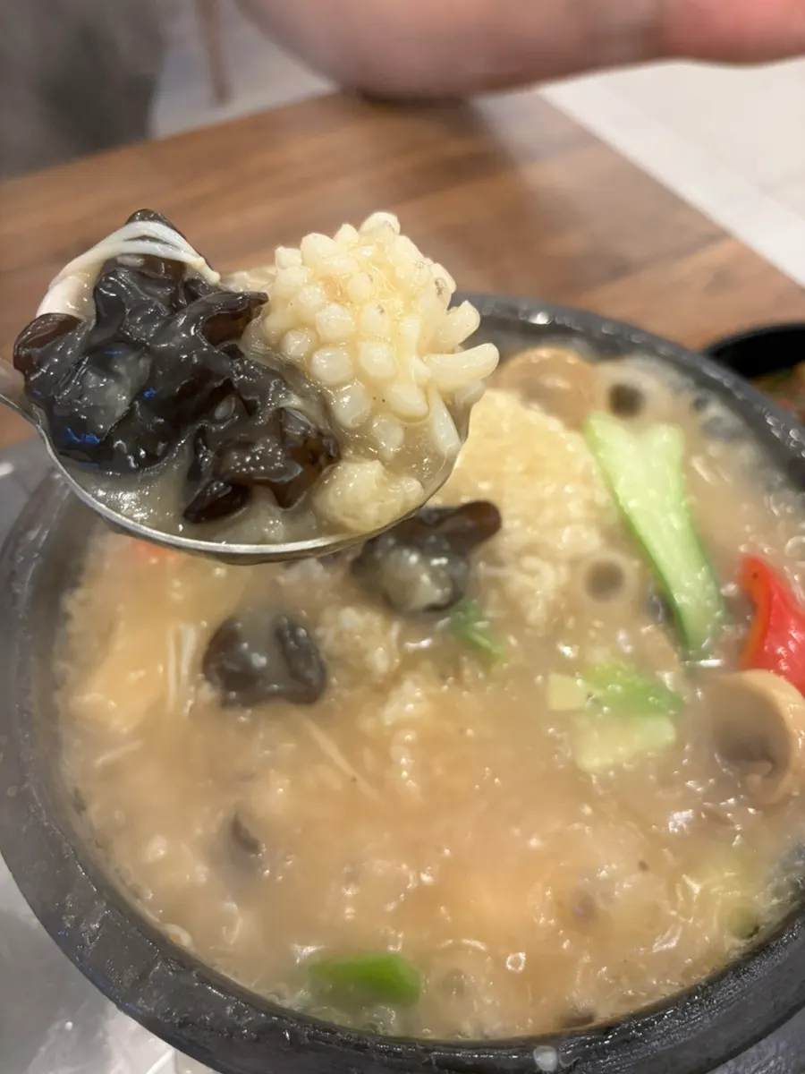 Seafood nurungji-tang finished by pouring sauce into a stone pot