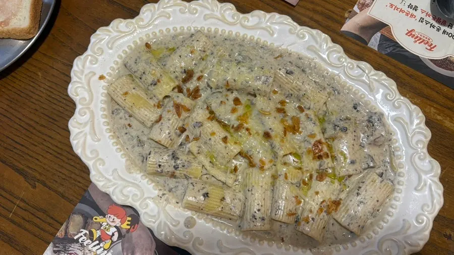 Close-up of the truffle cream pasta topped with mushrooms