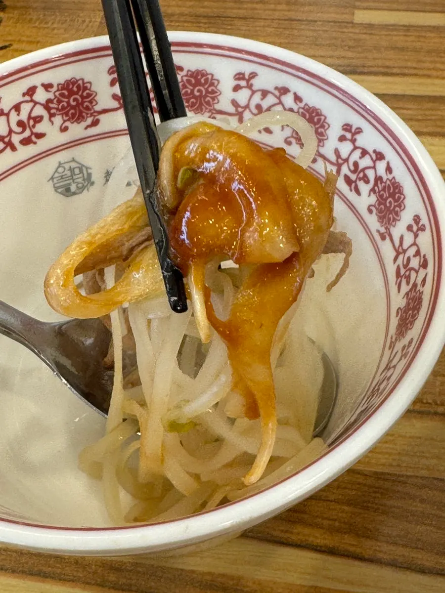 Noodles and meat lifted together from the pho bowl