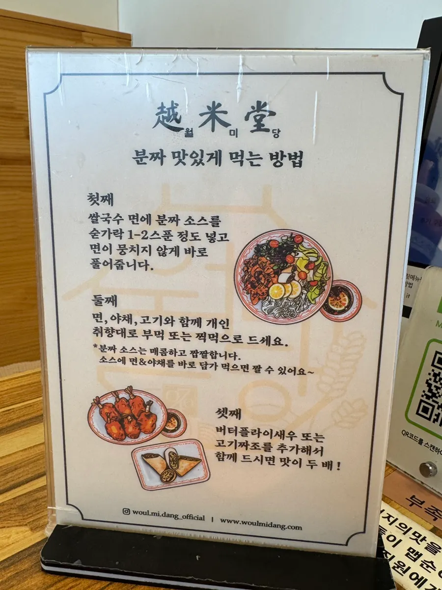 A plate of bun cha with meat, noodles, vegetables, and cha gio