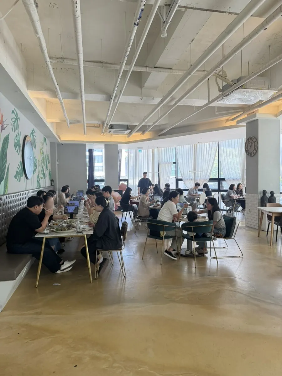 Interior of MooDoo Cheomdan with exposed ceiling and floor-to-ceiling windows