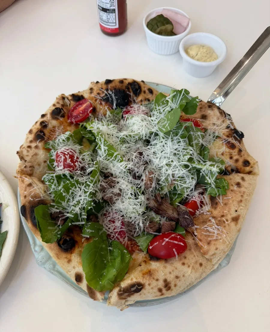 Rugola steak pizza fresh from the wood-fired oven