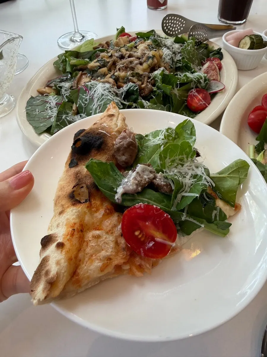 A pizza slice wrapped around steak and rugola