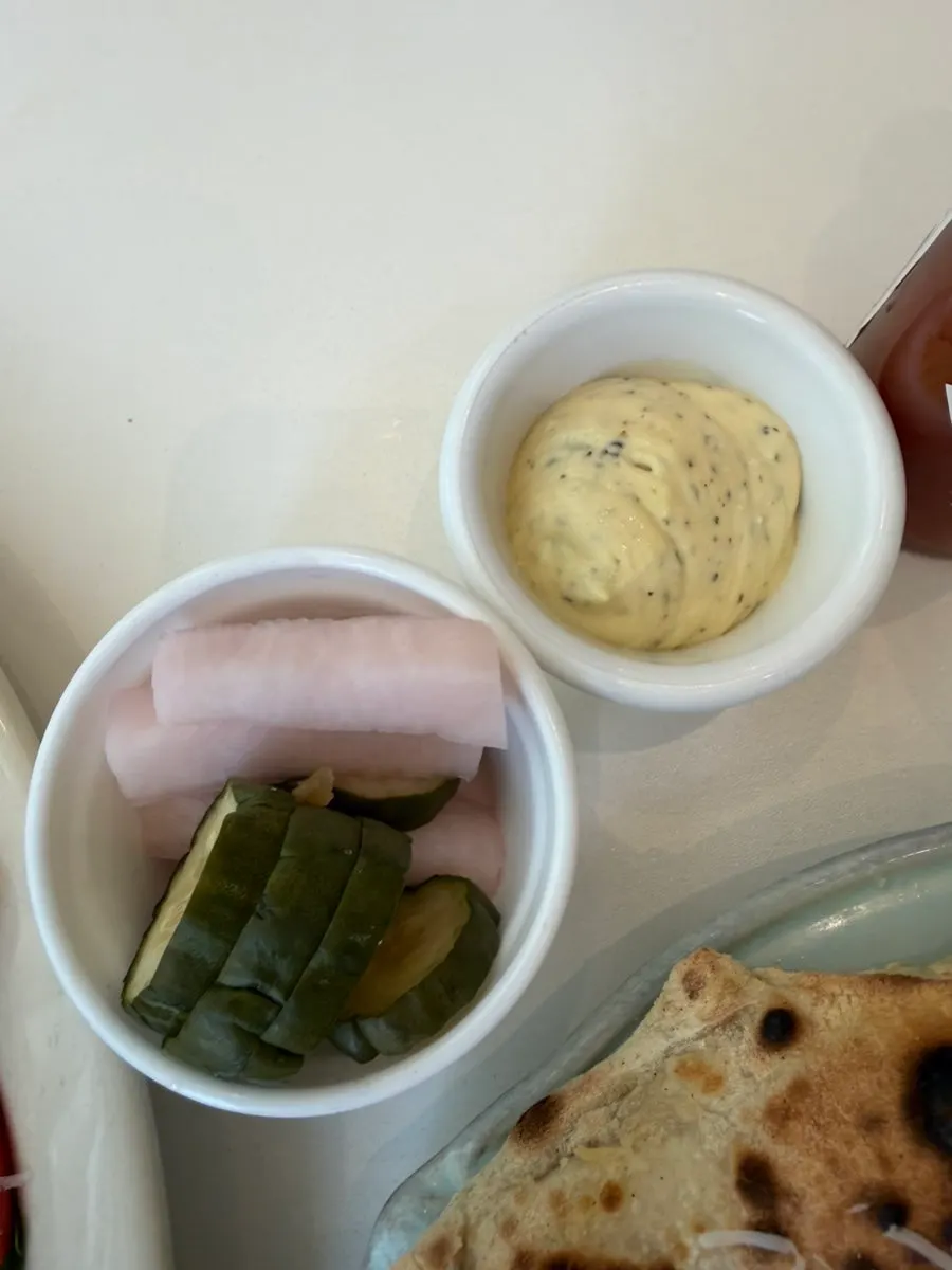 Pizza served with house pickles and dipping sauce