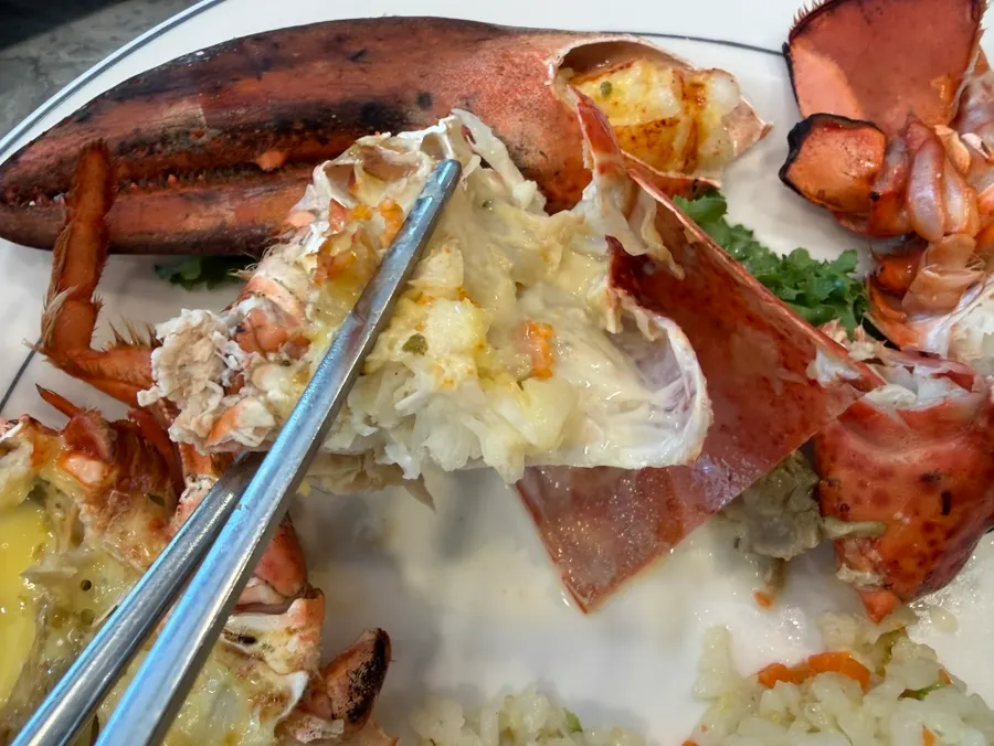 Thick lobster meat sliding easily out of the shell