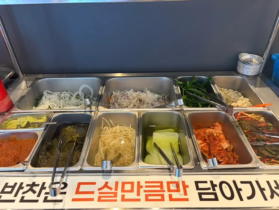 Side dish spread with pickled perilla leaves, sliced onion and green onion kimchi
