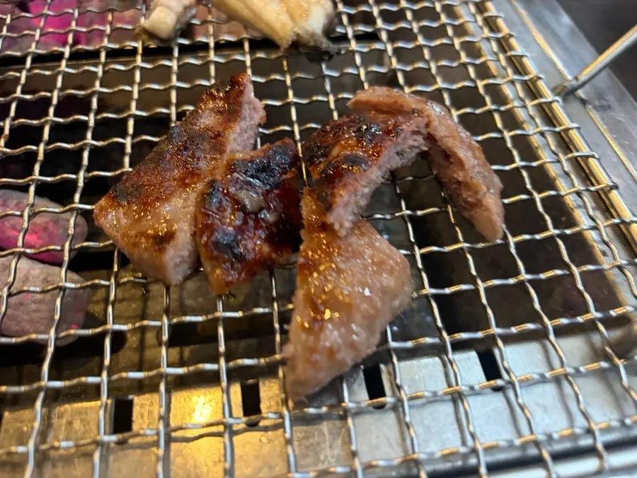 Pre-seared eel being finished on the grill, side facing down