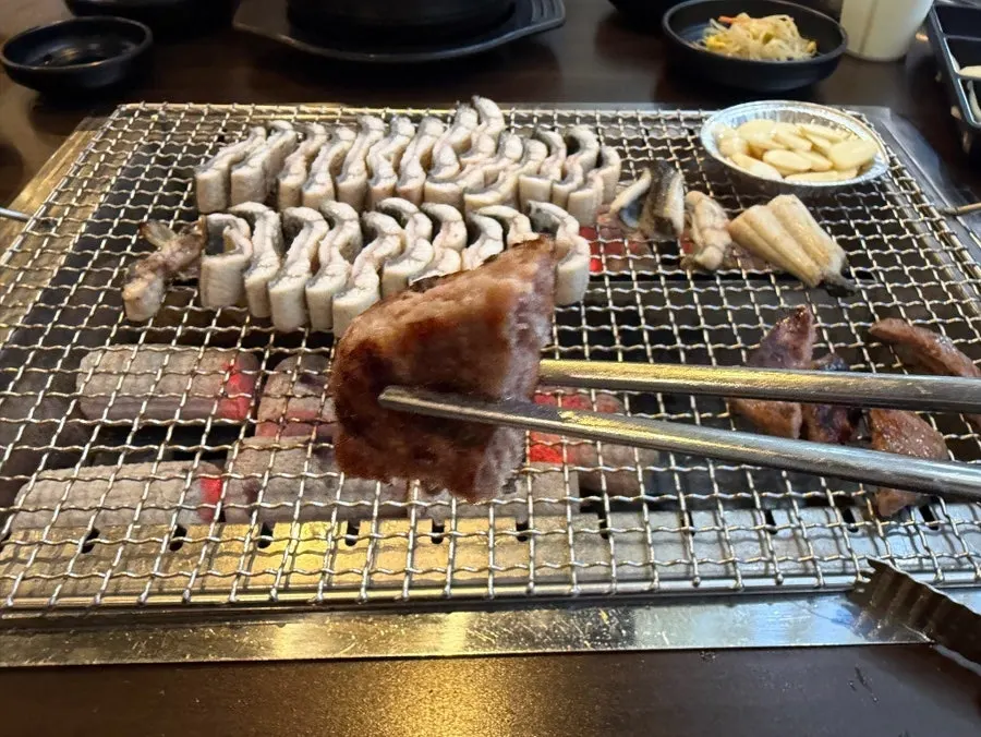 Eel grilling over gentle, not overly strong, charcoal heat