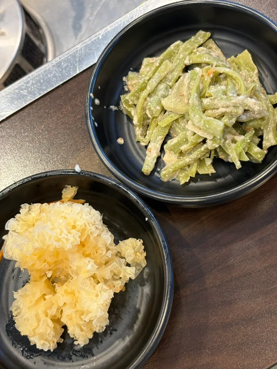 Plates of cold cucumber soup and lettuce among the side dishes