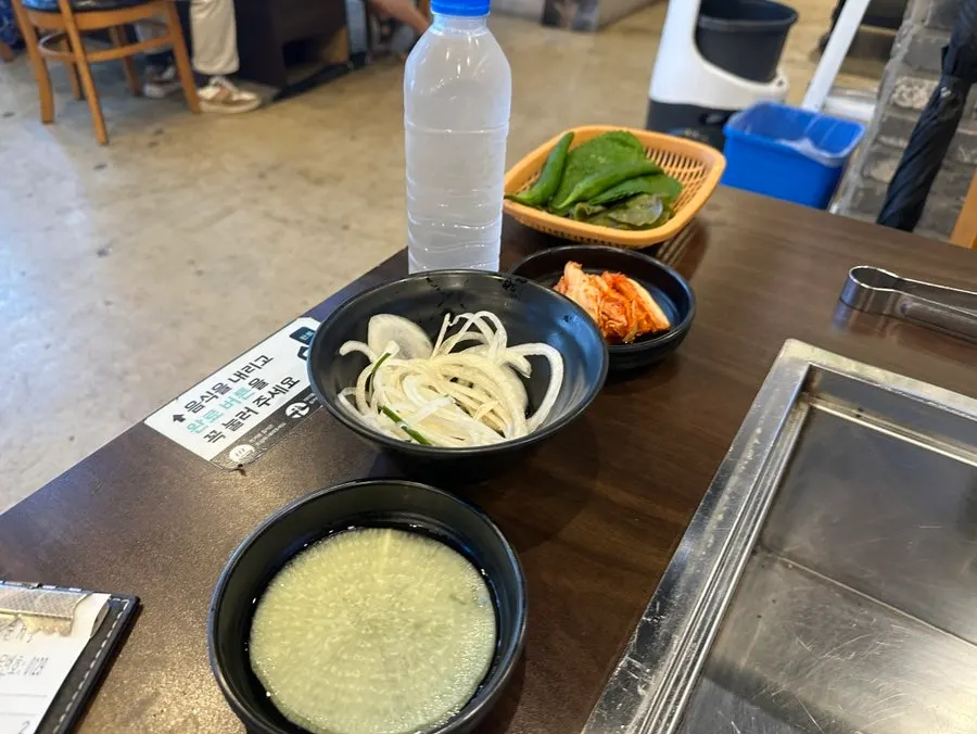 Self-serve sauce corner with salt, pepper, sesame oil and ssamjang
