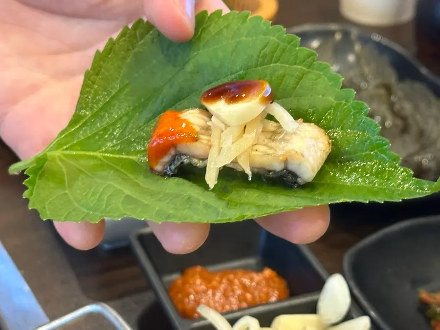 Eel wrapped in perilla leaf with raw garlic and ginger