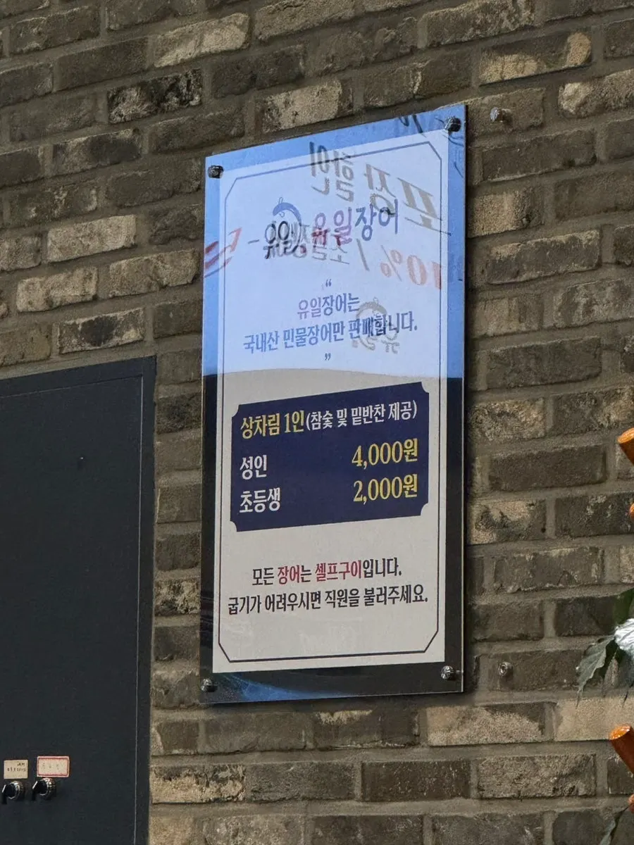 Sign showing table-setting fee and menu at Yuil Jangeo