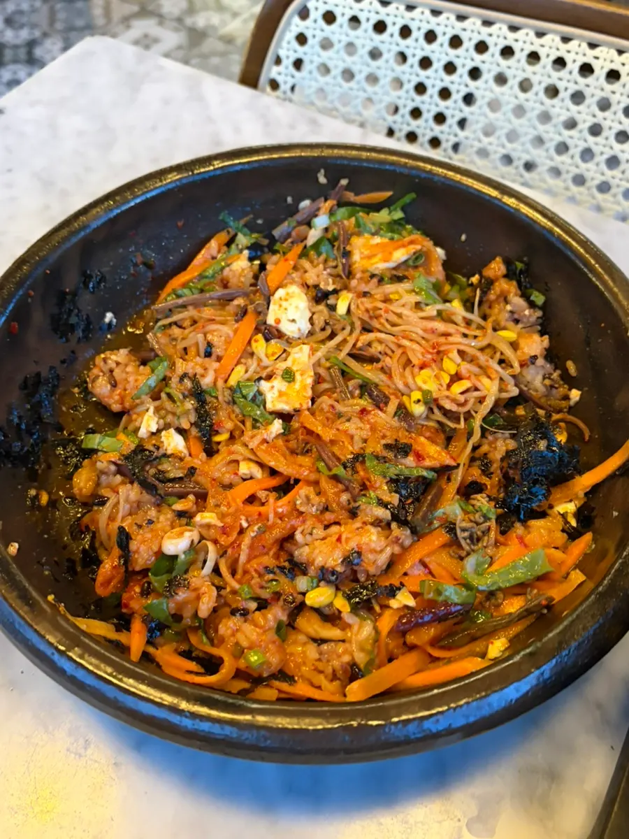 Seasonal bibimbap topped with a soft-cooked egg