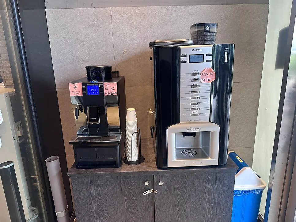 Two self-serve coffee machines near the entrance