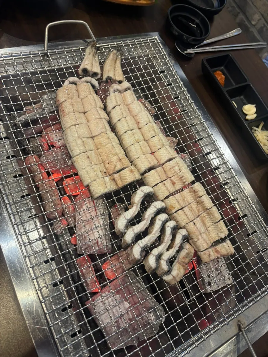 Par-grilled eel over charcoal