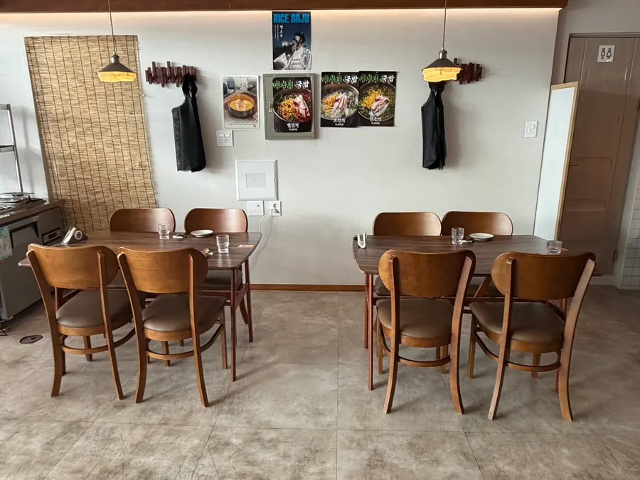 The Jumak Inho interior with wood-toned tables and lighting