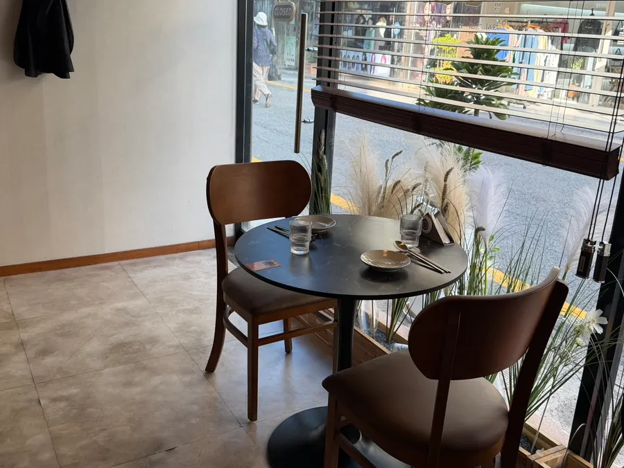 The interior with regular tables and bar-style seating