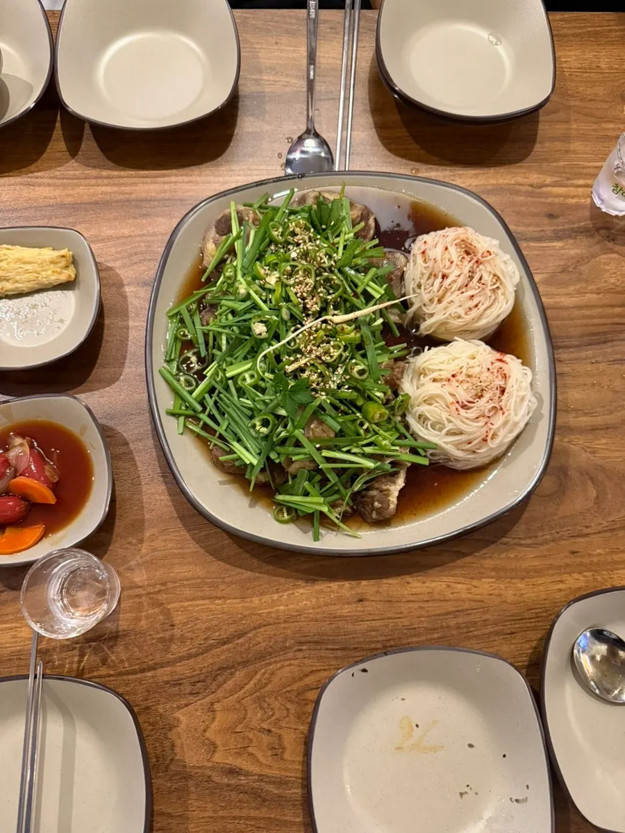 A plate of side dishes including stir-fried sausage and black beans